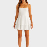 Carla - Mini vestido sin espalda con tirantes con lazo y falda en capas